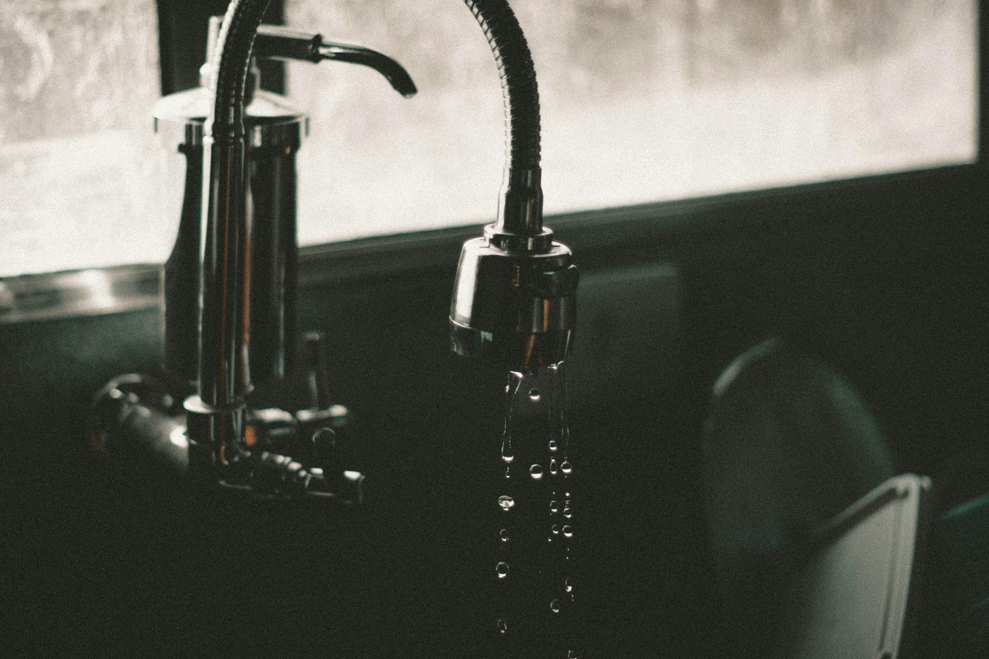 Water dripping from a modern kitchen faucet