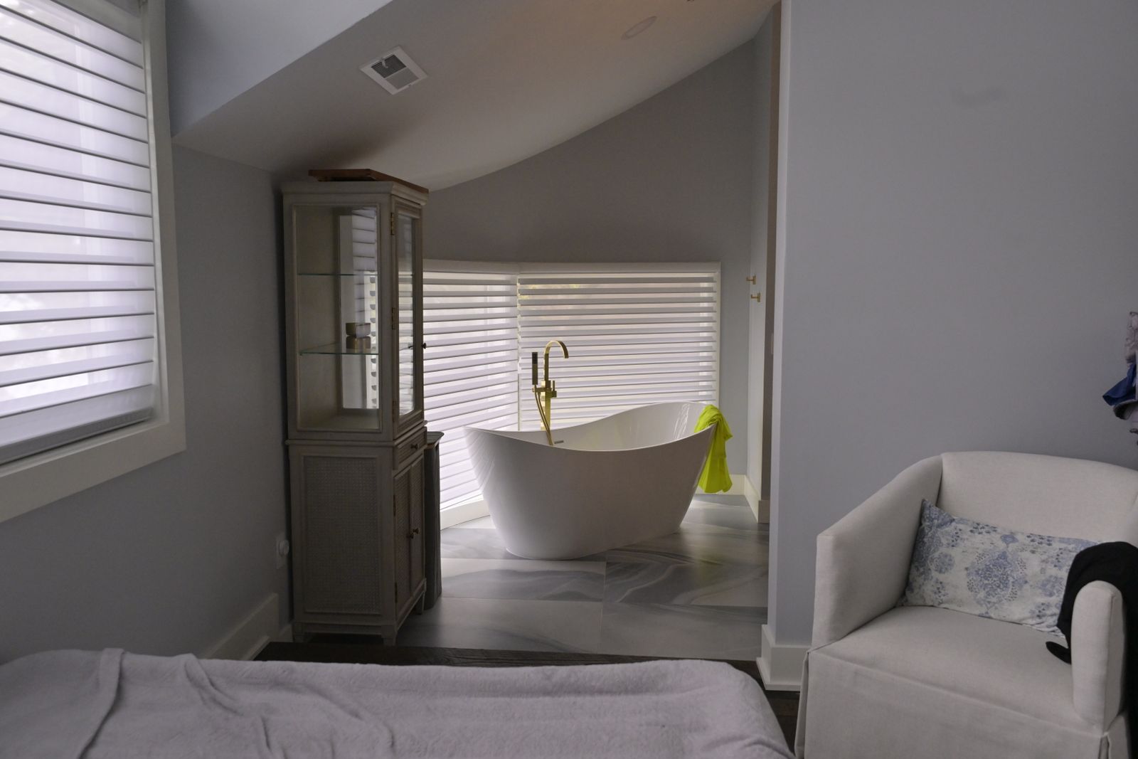 Freestanding white tub in a modern tiled bathroom